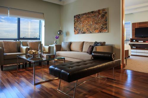 a living room with a couch and a table at Renaissance São Paulo Hotel in Sao Paulo