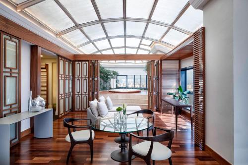 a glass ceiling in a living room with a glass table at Renaissance São Paulo Hotel in Sao Paulo