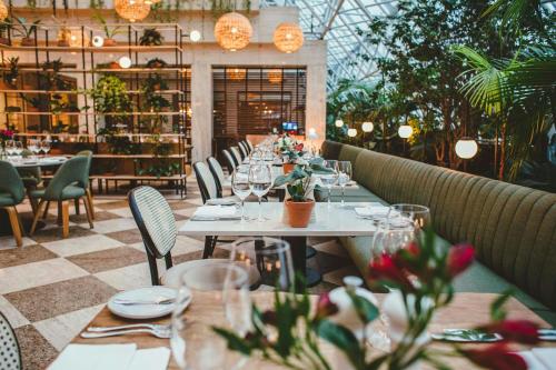 a dining room with tables and chairs with wine glasses at Renaissance São Paulo Hotel in Sao Paulo
