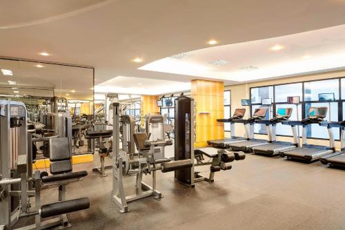 a gym with rows of tread machines and mirrors at Renaissance São Paulo Hotel in Sao Paulo