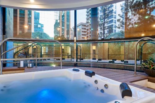 a bath tub in a building with a view of the city at Renaissance São Paulo Hotel in Sao Paulo