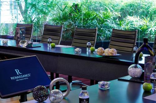 a table with a laptop on it with food on it at Renaissance São Paulo Hotel in Sao Paulo