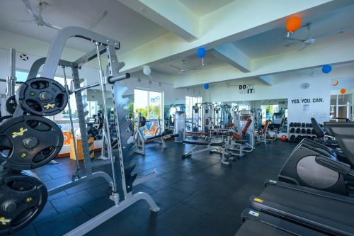 a gym with several treadmills and machines at Stylish 2 Bedroom Apt Mombasa Pool, Gym, AC, Secure and Central in Mombasa