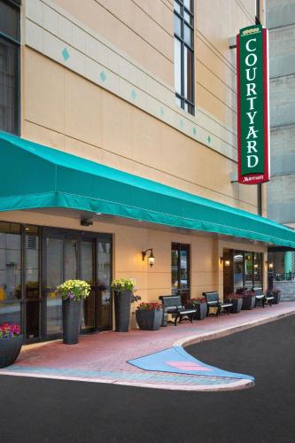 a hotel building with a sign in front of it at Courtyard Wilmington Downtown in Wilmington