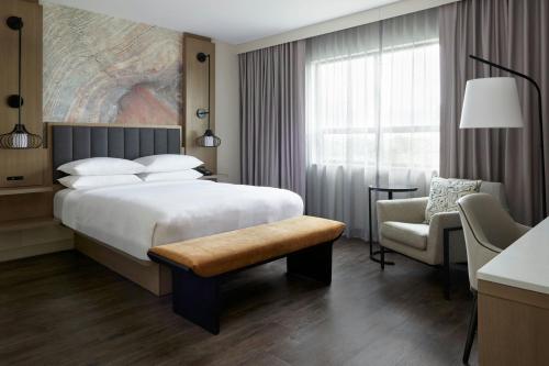 a hotel room with a bed and a chair at Kingston Marriott Hotel in Kingston