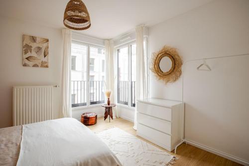 ein weißes Schlafzimmer mit einem Bett und einem Fenster in der Unterkunft 2 room apartment near PARIS and Metro line 4 in Bagneux