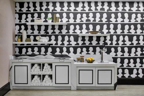 a kitchen with a white counter and a wall at Le Pavillon, New Orleans, a Tribute Portfolio Hotel in New Orleans