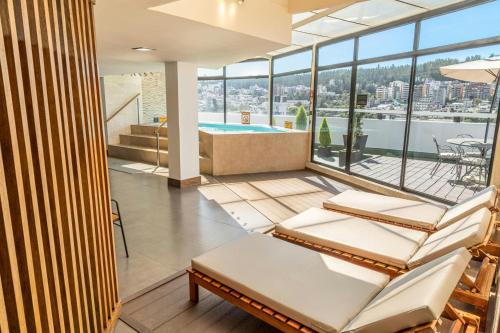 a living room with a pool and views of the city at Sheraton Quito in Quito