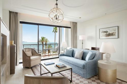 a living room with a couch and a table at The St. Regis La Bahia Blanca Resort - Tamuda Bay in Fnidek