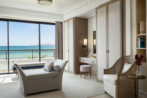 a living room with a view of the ocean at The St. Regis La Bahia Blanca Resort - Tamuda Bay in Fnidek