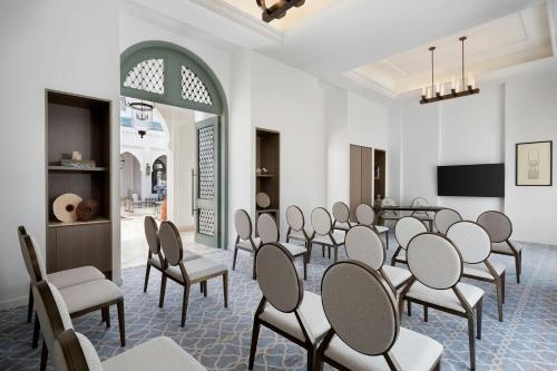 a conference room with chairs and a flat screen tv at The St. Regis La Bahia Blanca Resort - Tamuda Bay in Fnidek