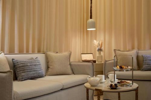 a living room with a couch and a table at The St. Regis La Bahia Blanca Resort - Tamuda Bay in Fnidek