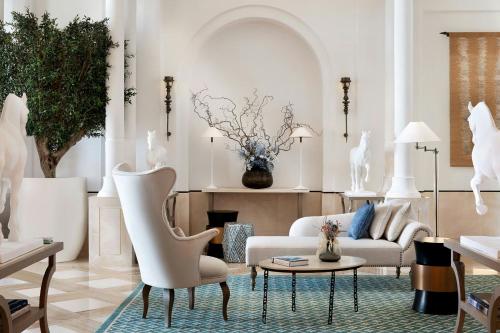 a living room with a couch and a table at The St. Regis La Bahia Blanca Resort - Tamuda Bay in Fnidek