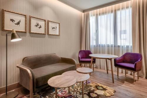 a living room with a couch and two chairs at Querencia de Sevilla, Autograph Collection in Seville