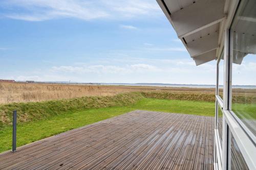 a view of a field from the porch of a house at Cozy Holiday Home On Orø in Orø