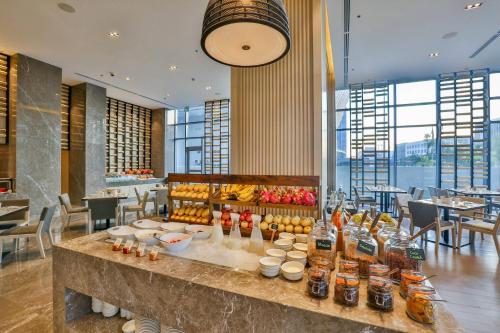 a bar in a restaurant with drinks on a table at Courtyard by Marriott Iloilo in Iloilo City