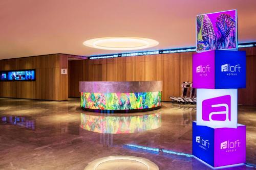 a lobby with a stage in the middle of a room at Aloft Taipei Beitou in Taipei