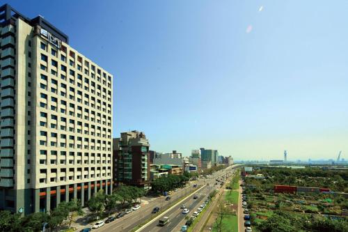 a view of a city with a highway and buildings at Aloft Taipei Beitou in Taipei