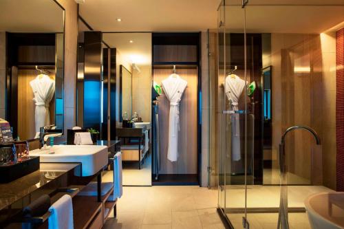 a bathroom with a shower and a sink and a sink at Aloft Taipei Beitou in Taipei