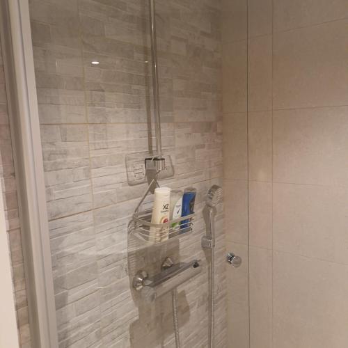 a shower in a bathroom with a glass door at Askaistentie 29 in Turku