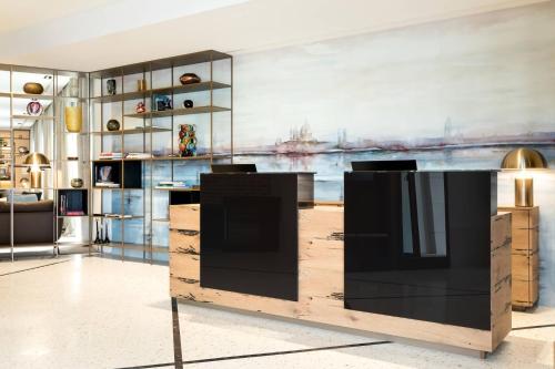 a living room filled with furniture and a painting at AC Hotel Venezia by Marriott in Venice