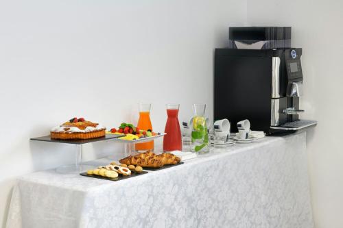 a table with food and drinks on a counter at AC Hotel by Marriott Milan Sesto in Sesto San Giovanni