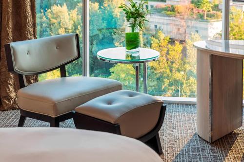 a room with two chairs and a table and a window at Renaissance Santiago by Marriott in Santiago