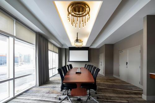 a conference room with a table and chairs at Courtyard by Marriott Montreal Airport in Dorval