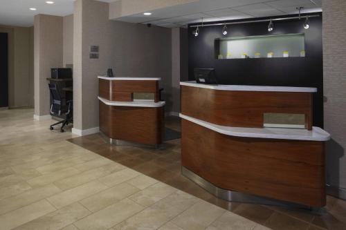 an office with two reception desks in a lobby at Courtyard Indianapolis Northwest in Indianapolis
