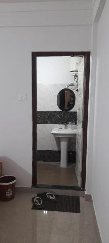 a bathroom with a sink and a mirror at Astoria Rest Nest Homestay in Darjeeling