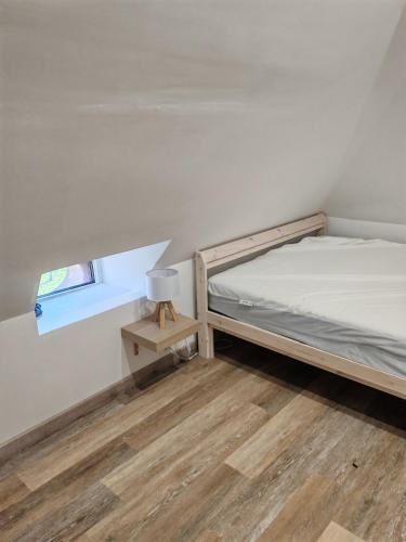 a small bedroom with a bunk bed and a window at Gite a collonges la rouge avec spa in Collonges la rouge