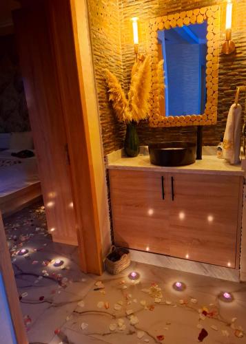 a bathroom with a sink and a mirror at Azur appartement essaouira in Essaouira