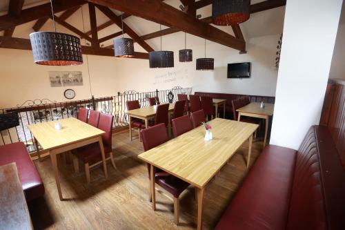 a dining room with wooden tables and chairs at Lyons Manor House Caravan Park in Mawbray