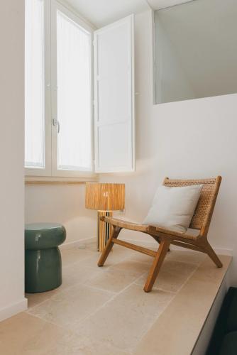 a room with a rattan chair and a lamp at Santa Maria 24 in Monopoli