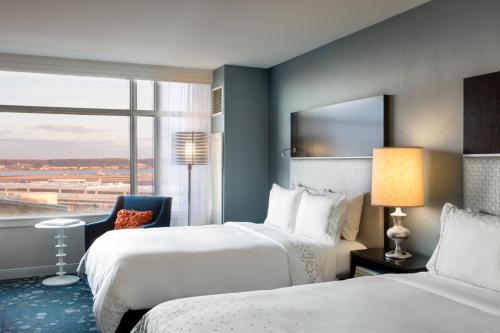 a hotel room with two beds and a window at Renaissance Arlington Capital View Hotel in Arlington