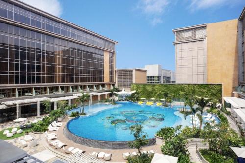 an overhead view of a large swimming pool in a city at Sheraton Manila Hotel at Newport World Resorts in Manila