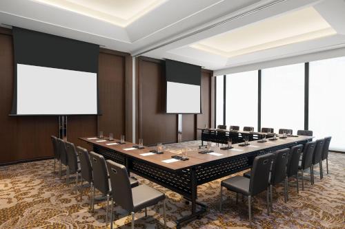 a large conference room with a long table and chairs at Sheraton Manila Hotel at Newport World Resorts in Manila