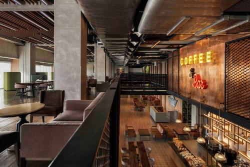a lobby with a bar with couches and tables at Sheraton Manila Hotel at Newport World Resorts in Manila