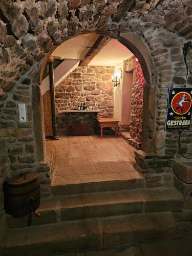 an archway in a stone building with a table at Froschgass Apartments in Klingenberg am Main