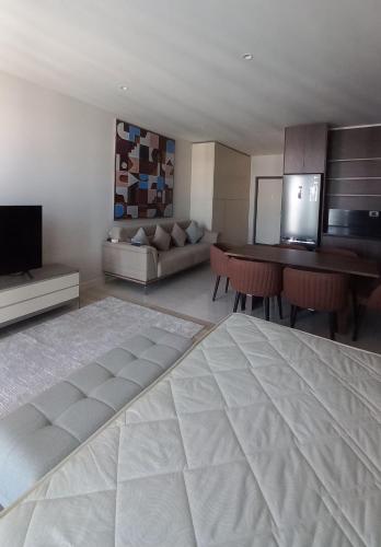 a living room with a large bed and a couch at Baku, Seabreeze, Park Residence 2 in Baku