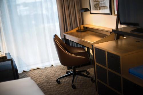 a room with a desk and a chair in a hotel room at Renaissance Toledo Downtown Hotel in Toledo