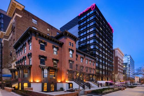 a large brick building with a tall skyscraper at Moxy Washington, DC Downtown in Washington