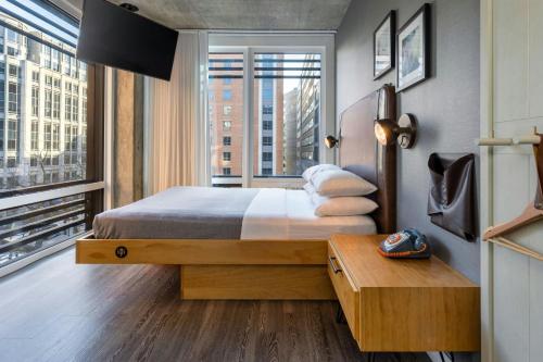 a bedroom with a bed and a large window at Moxy Washington, DC Downtown in Washington