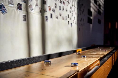 a long wooden table with cups on top of it at Moxy Washington, DC Downtown in Washington