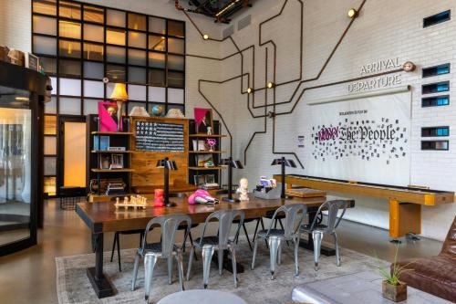 a dining room with a table and chairs and a piano at Moxy Washington, DC Downtown in Washington