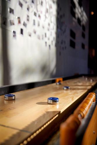 a table with three ping pong balls on top of it at Moxy Washington, DC Downtown in Washington
