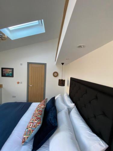 a bedroom with a bed with a black head board at 1 bedroom suite in Holt with parking in Holt