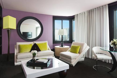 a living room with purple walls and a mirror at THE PLAZA Seoul, Autograph Collection in Seoul
