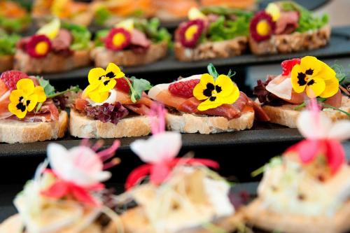 a bunch of sandwiches with flowers on them at Renaissance Warsaw Airport Hotel in Warsaw