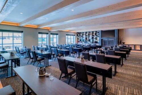 a large dining room with tables and chairs at The Cloudveil, Autograph Collection in Jackson